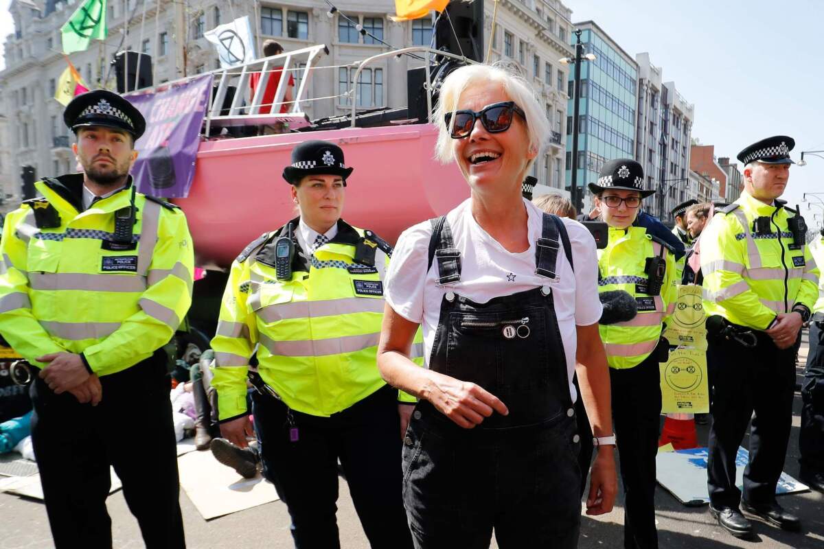 Emma Thompson, center, flanked by police as climate change activists occupy Oxford Circus in central London on April 19 during the fifth day of an environmental protest by the Extinction Rebellion group.