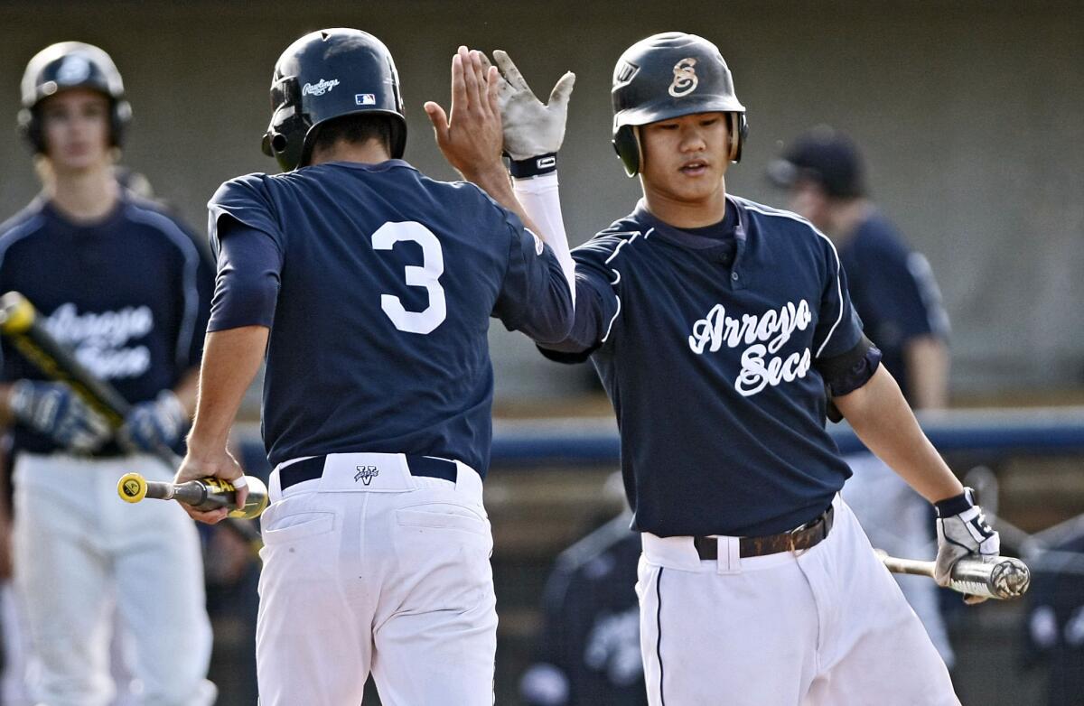 Pasadena's Arroyo Seco Saints player #3 Corey Dempster gets a high five from player #8 Troy Prasertsit after Dempster scored a run in game vs. San Jose Giants in the Palomino West Zone Tournament at Urban Youth Academy field in Compton on Friday, July 26, 2013. Arroyo Seco dropped the game 1-3.