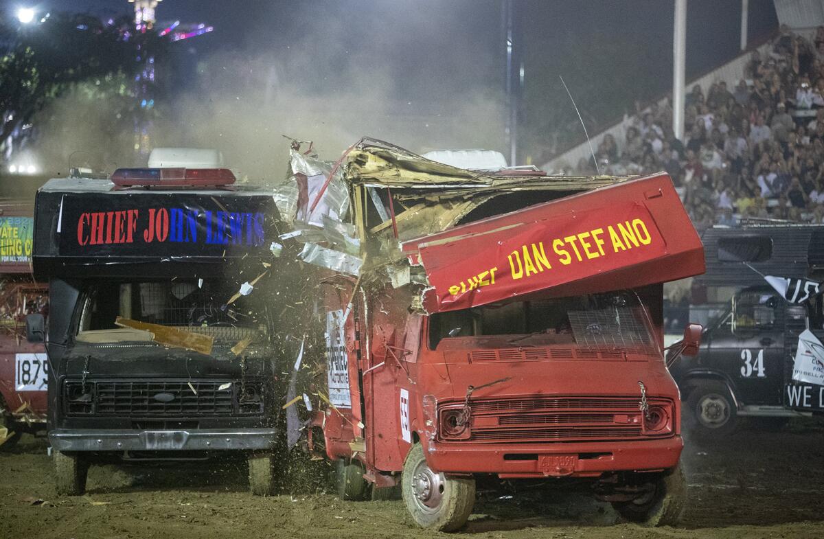 Newport Beach Police Chief Jon Lewis and Costa Mesa Fire Chief Dan Stefano go head to head during the Orange County Fair's Motorhome Madness demolition derby Friday night.