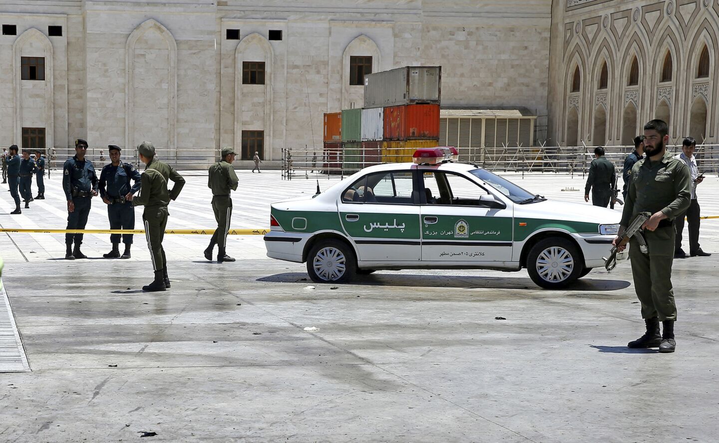 Police officers patrol around the shrine of late Iranian revolutionary founder Ayatollah Khomeini, after an attack.