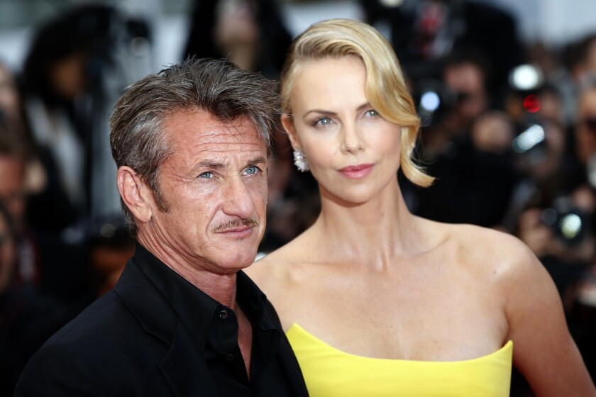 Charlize Theron, right, debunks some myths behind her romance with actor Sean Penn.