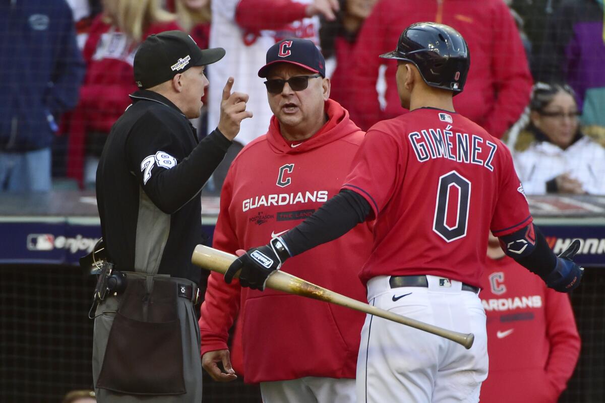 Cleveland Guardians manager Terry Francona, center, argues with home plate umpire Adam Hamari (78) after Andres Gimenez (0) was called out on strikes in the 12th inning of a wild card baseball playoff game against the Tampa Bay Rays, Saturday, Oct. 8, 2022, in Cleveland. (AP Photo/Phil Long)