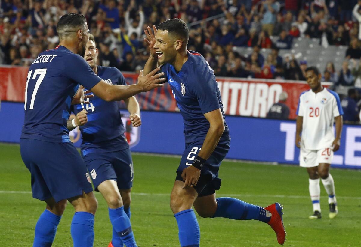 United States forward Christian Ramirez, middle, celebrates his goal with midfielder Sebastian Lletget (17) and midfielder Paul Arriola (14) as Panama midfielder Rolando Botello (20) pauses on the field during the second half of a men's international friendly soccer match Sunday, Jan. 27, 2019, in Phoenix. The United States defeated Panama 3-0.