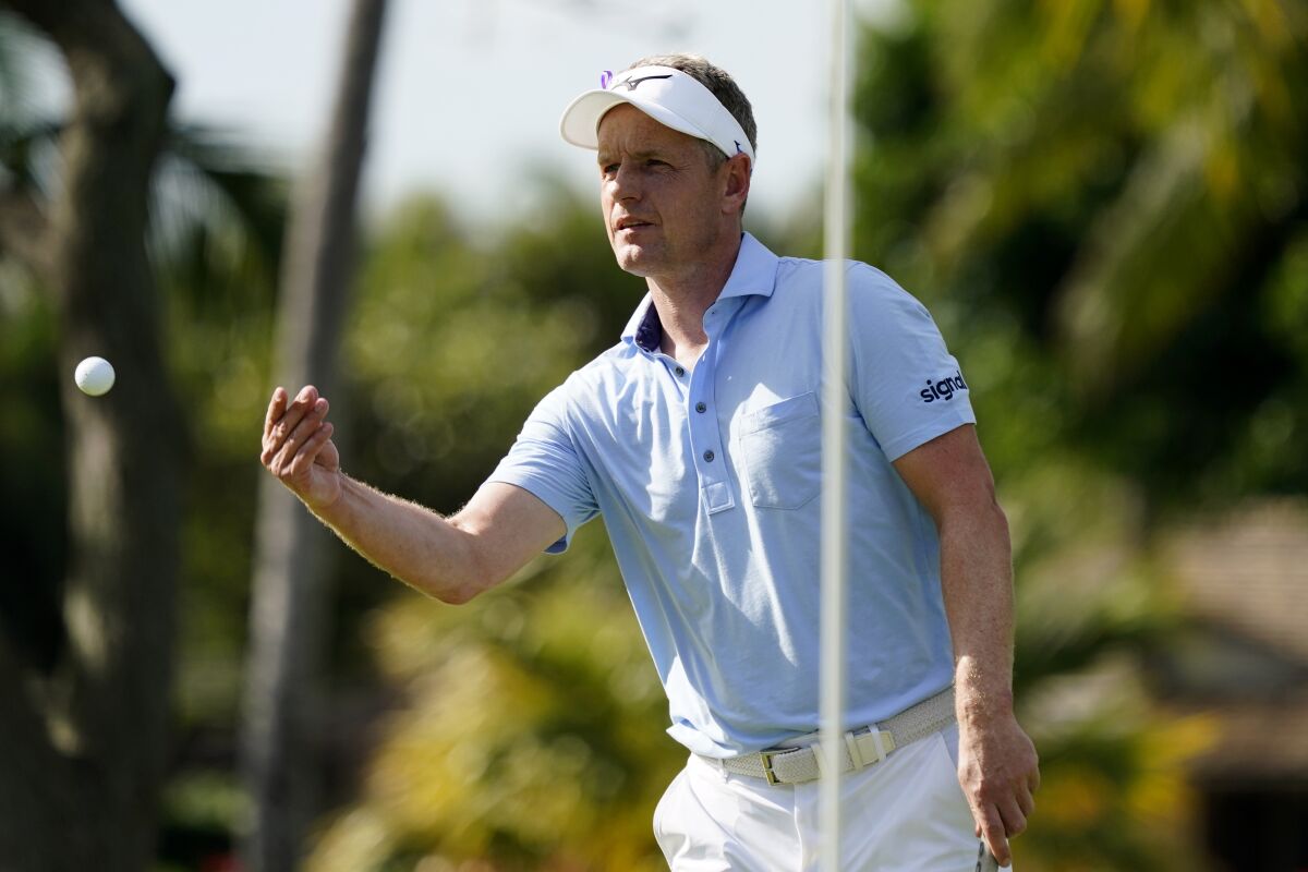 Luke Donald throws his ball to his caddie on the 10th green during the first round of the Sony Open golf tournament, Thursday, Jan. 13, 2022, at Waialae Country Club in Honolulu. (AP Photo/Matt York)