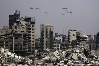 Parachutes over a ruined city landscape.