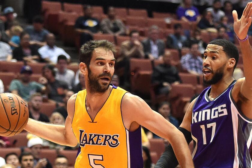 The Lakers' Jose Calderon drives against Sacramento's Garrett Temple on Oct. 4.
