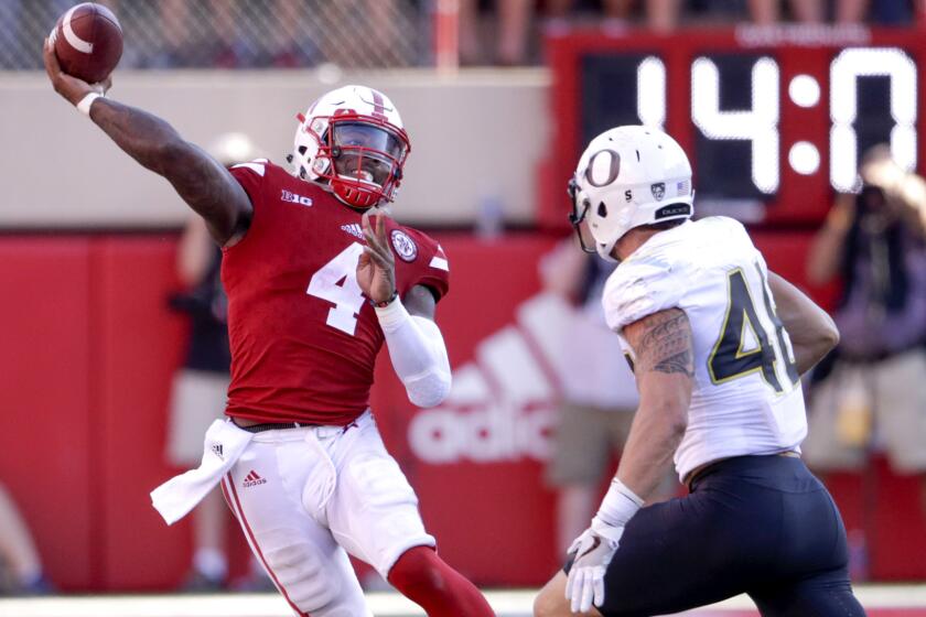 Nebraska quarterback Tommy Armstrong Jr. throws on the run while pressured by Oregon linebacker Danny Mattingly during the second half Saturday.