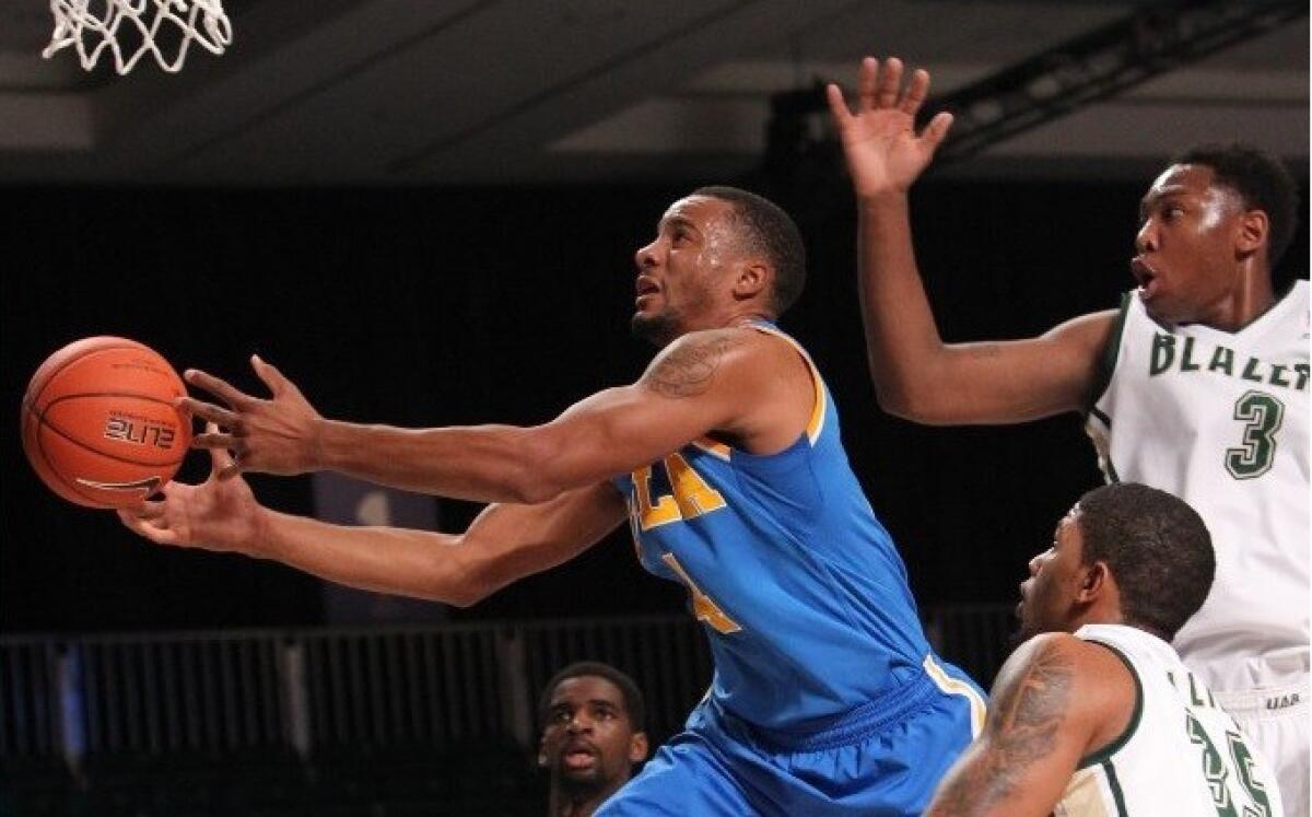 UCLA guard Norman Powell tries to keep possession of the ball against UAB forwards Chris Cokley (3) and Lewis Sullivan (35) during the Bruins win Friday over the Blazers, 88-76, at the Battle 4 Atlantis.