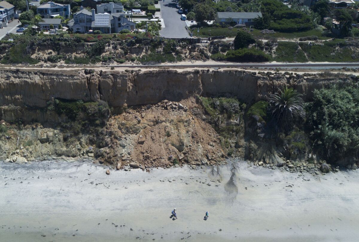  Walkers kept their distance from the eroding cliffs in Del Mar in August 2019. 