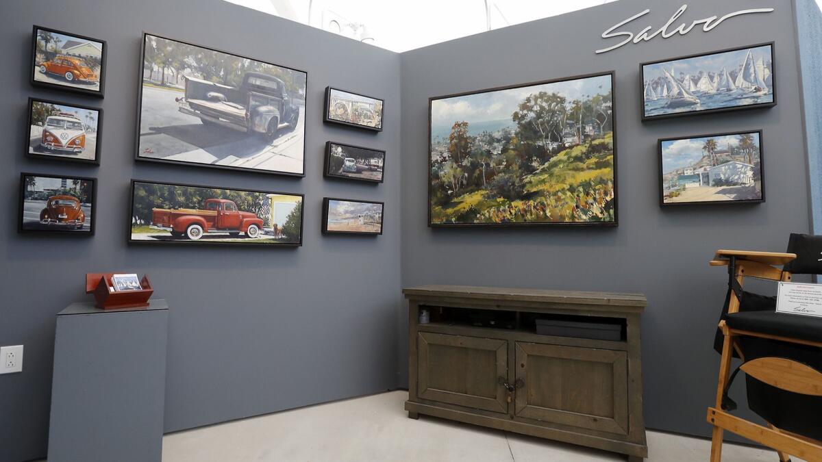 Paintings of vintage vehicles and landscapes by artist Anthony Salvo of Costa Mesa are displayed at the 2019 Festival of Arts in Laguna Beach. The summer festival is Salvo's biggest annual revenue source.