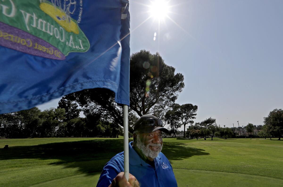 Glen Porter tends a flag stick at Maggie Hathaway Golf Course.