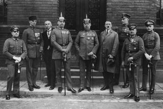 The principal collaborators of the failed Munich Beer Hall uprising pose after their trial. They are, from left to right, Pernet, Weber, Frick, Kriebel, General Ludendorff, Adolf Hitler, Bruckner, Rohm and Wagner. (Photo by © Hulton-Deutsch Collection/CORBIS/Corbis via Getty Images)