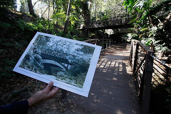 Bernadette Soter of Friends of Griffith Park holds photos of Fern Dell's glory days. The volunteer group has launched a campaign to restore the area.