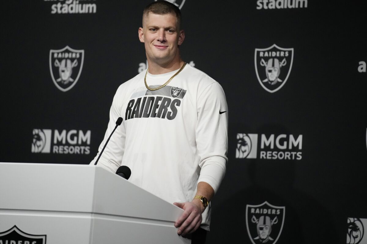 Carl Nassib at a lectern for a news conference