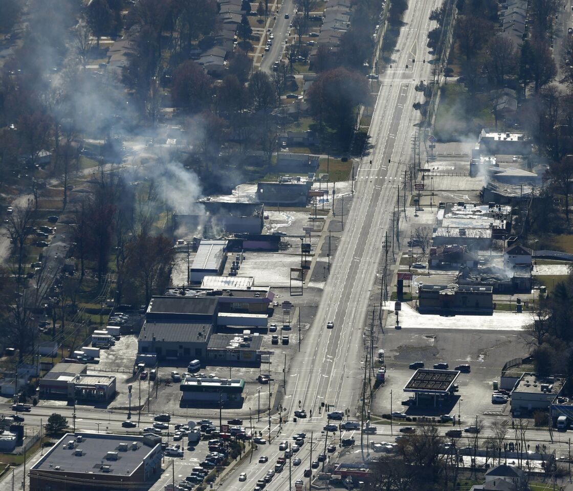 Fires smolder along a closed stretch of street in Ferguson, Mo., in an aerial photo.