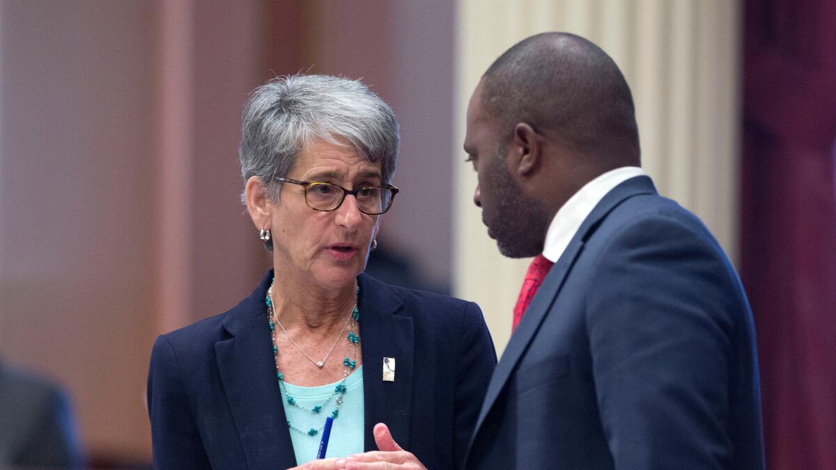 State Sen. Hannah-Beth Jackson, D-Santa Barbara, talks with Assemblyman Tony Thurmond, D-Richmond, at the Capitol Wednesday