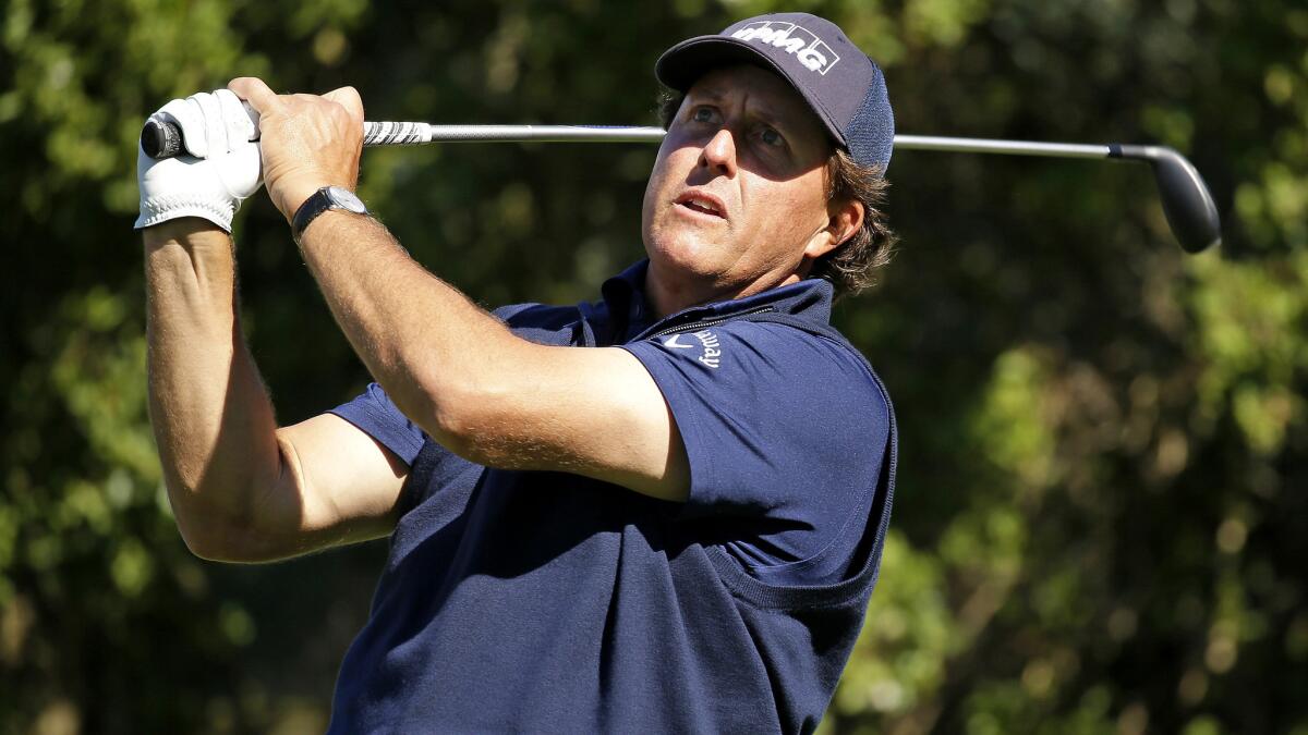 Phil Mickelson hits from the 16th tee at Pebble Beach Golf Links during the third round of the AT&T Pebble Beach National Pro-Am on Saturday.