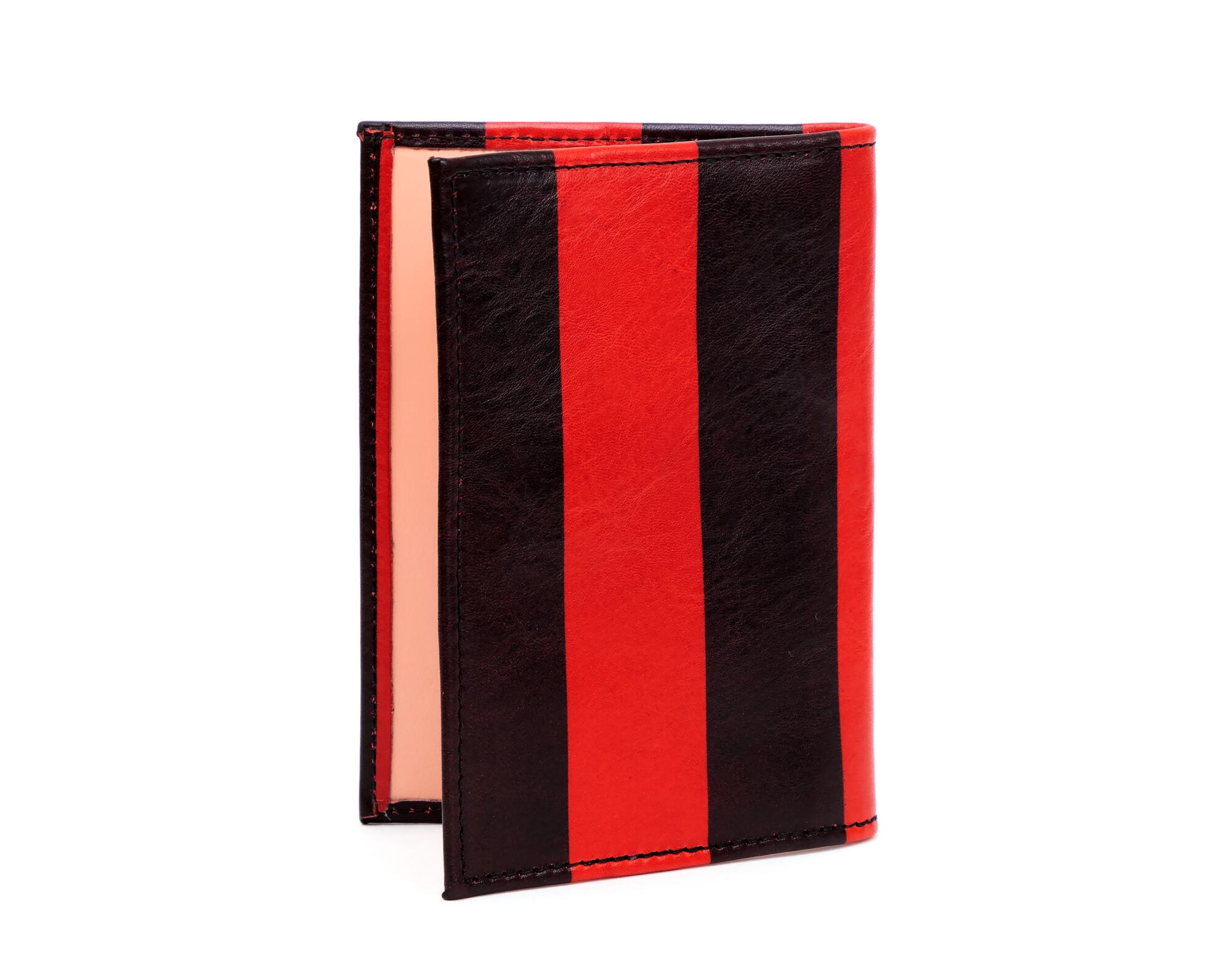 A red-and-black-striped passport case.
