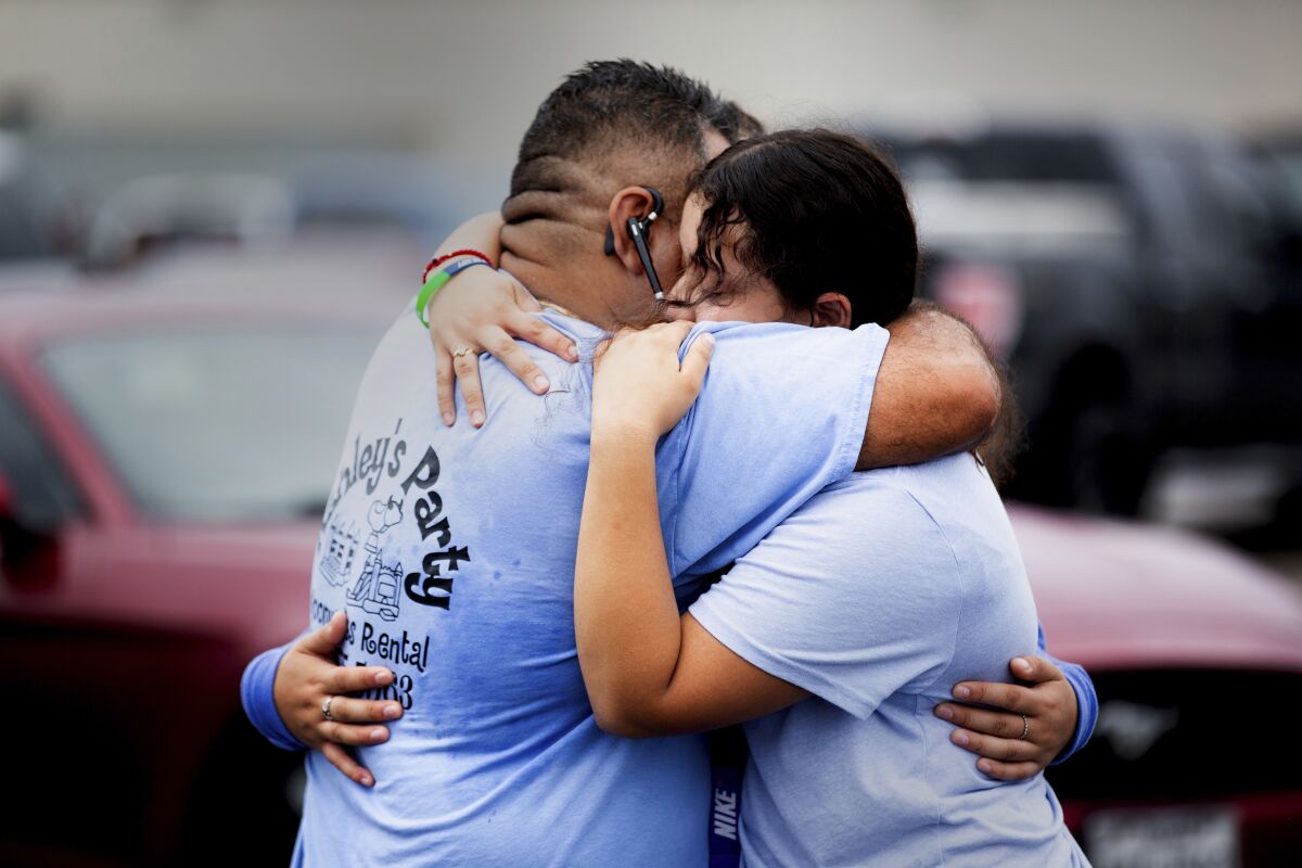 Yes Prep Southwest Secondary school 8th grader Kimberly Mendez, 14, right, to embrace her father Rudis and sister Ashley, 16, 11th grade, in a parking lot on the corner of Hiram Clarke Rd. and W. Fuqua St. after an alleged shooting took place at her school, YES Prep Southwest Secondary school, on Friday, Oct. 1, 2021, in Houston. An employee at the Houston charter school was shot and wounded by a former student, police said. Houston Police Chief Troy Finner said a 25-year-old man surrendered after being surrounded by police. (Marie D. De Jesús/Houston Chronicle via AP)