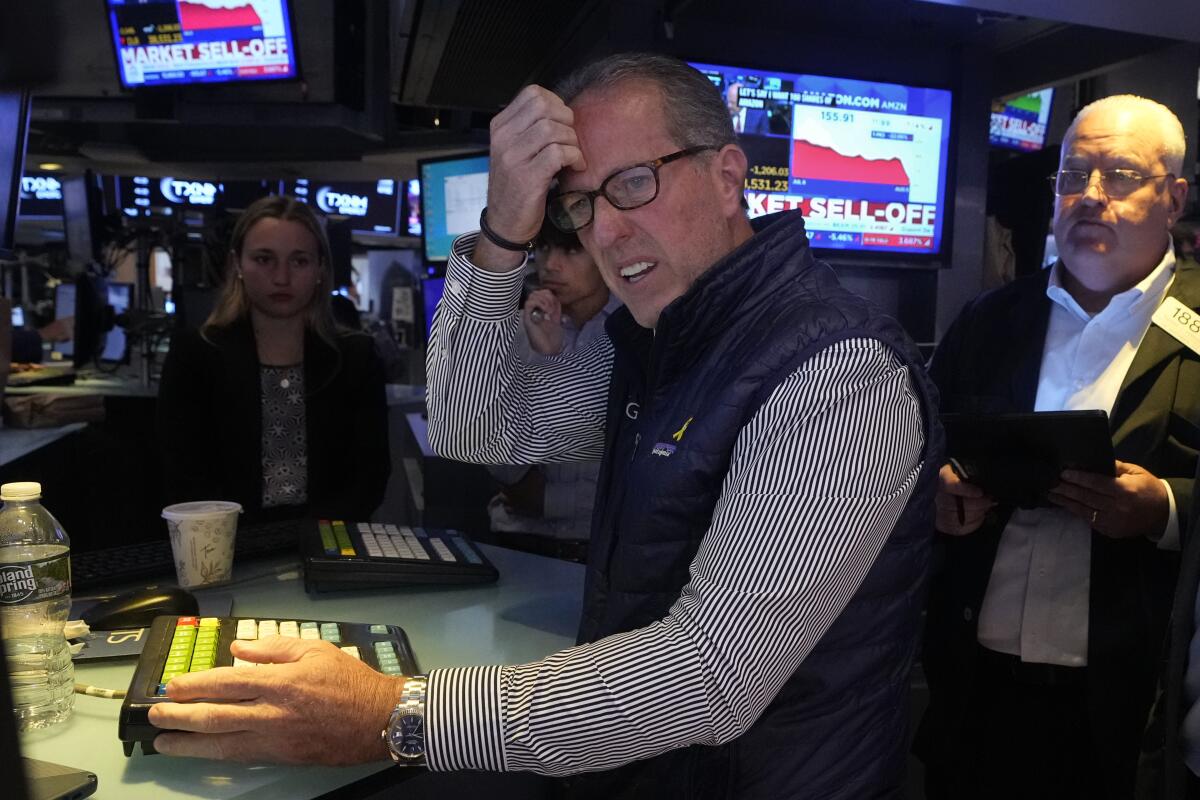 Specialist Glenn Carell works at his post on the floor of the New York Stock Exchange on Mondayu.