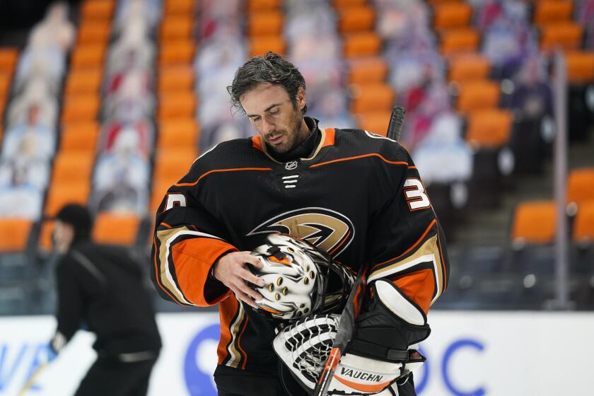 Anaheim Ducks goaltender Ryan Miller takes off his mask during the first period of an NHL hockey game against the Arizona Coyotes Saturday, March 20, 2021, in Anaheim, Calif. (AP Photo/Jae C. Hong)