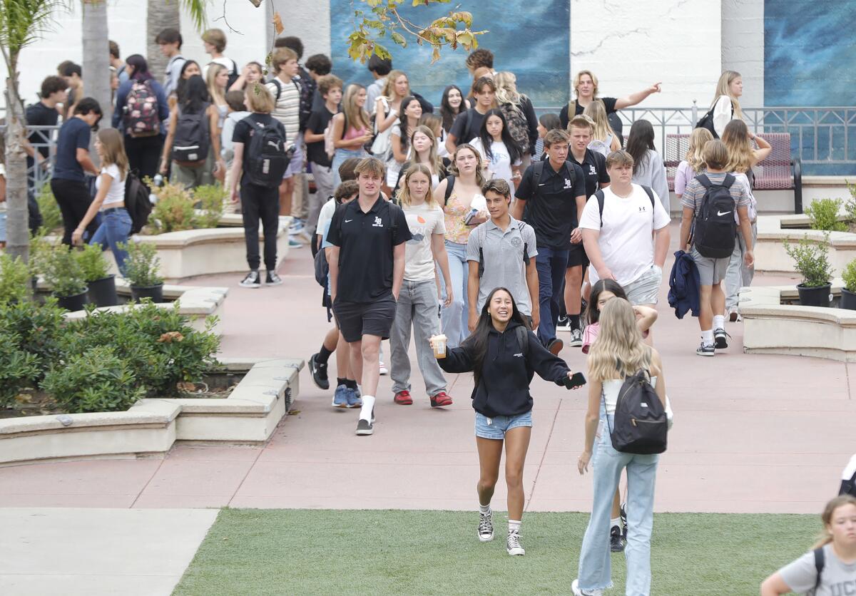 Students walk and greet each other on the first day of school at Laguna Beach High on Thursday morning.