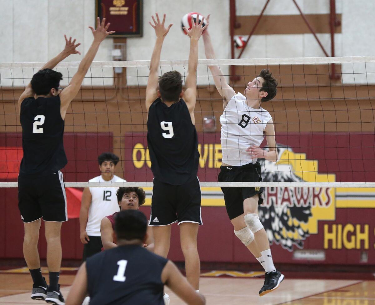 Ocean View High's Jackson Petrovich (8) tries to put a ball past Godinez's Cesar Mascareno (2) and Nathan Escobedo (15) in a Golden West League match on Thursday.