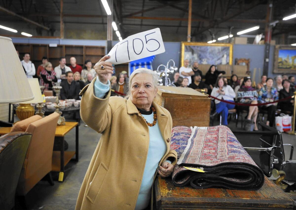 A woman bids at Abell Auction Company, Los Angeles' oldest auction house, on Feb. 4, 2016.
