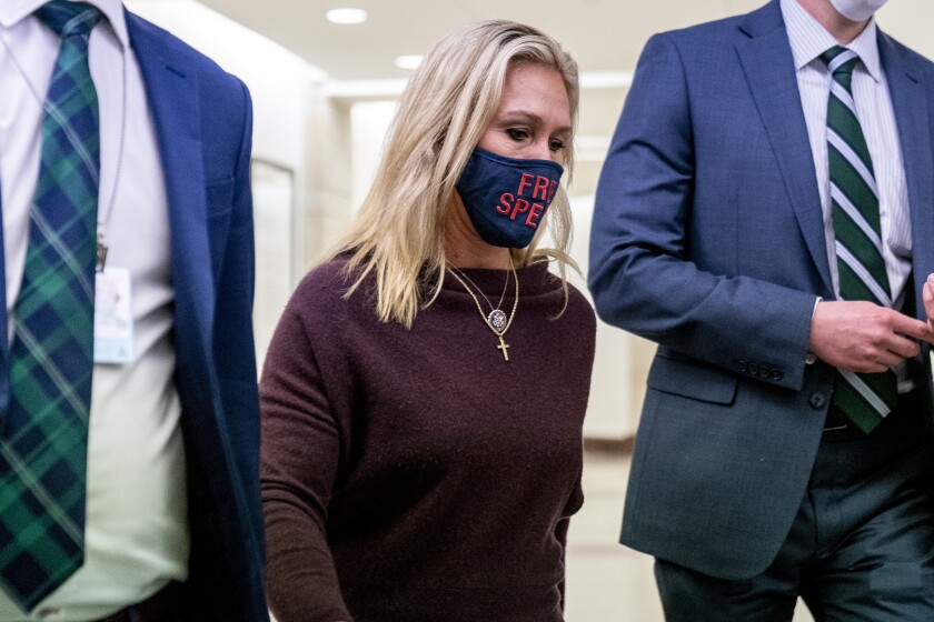 Rep. Marjorie Taylor Greene wears a mask with the words 'free speech' on it.