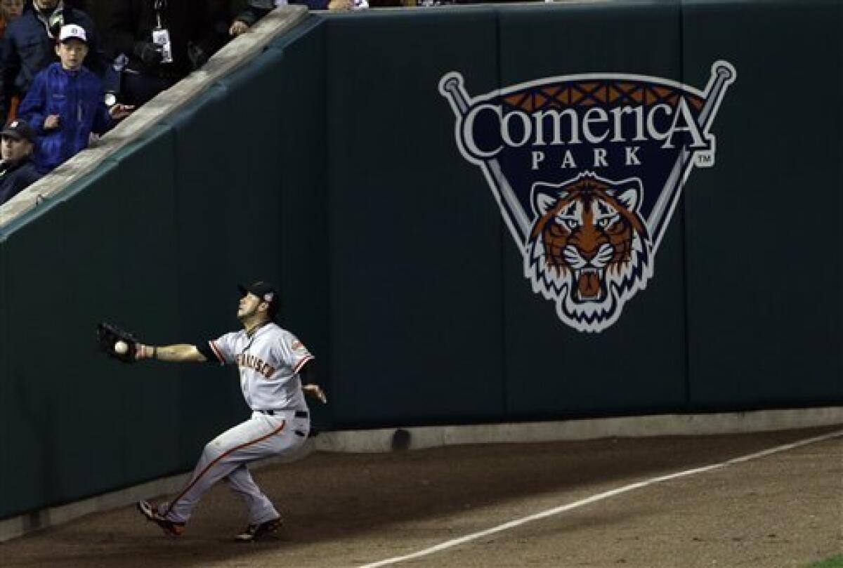 San Francisco Giants right fielder Gregor Blanco makes a catch near the wall of a ball hit by Detroit Tigers' Jhonny Peralta during the ninth inning of Game 3 of baseball's World Series Saturday, Oct. 27, 2012, in Detroit. (AP Photo/Paul Sancya )