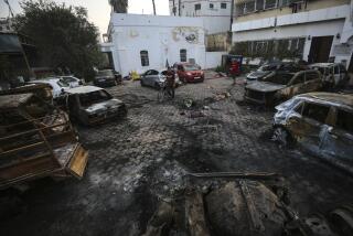 Palestinian men look over the site of a deadly explosion at al-Ahli Hospital in Gaza City, Wednesday, Oct. 18, 2023. (AP Photo/Abed Khaled)