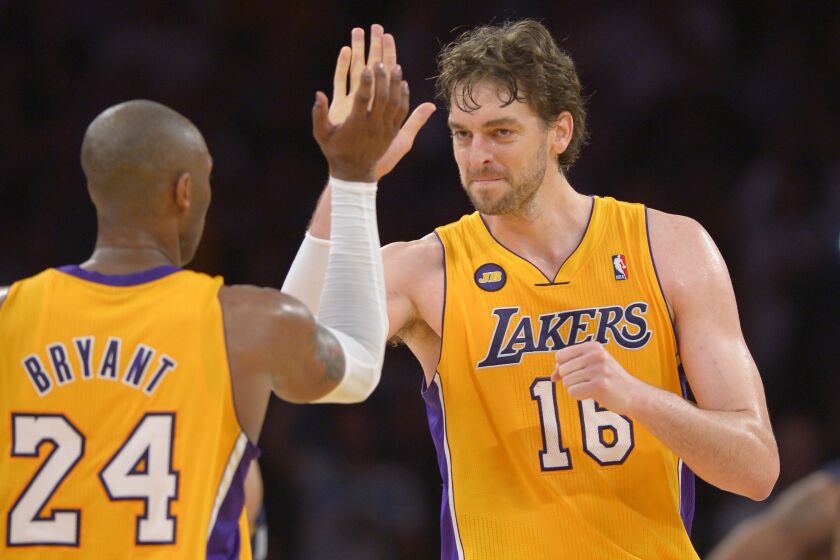 Los Angeles Lakers guard Kobe Bryant, left, is congratulated by forward Pau Gasol.