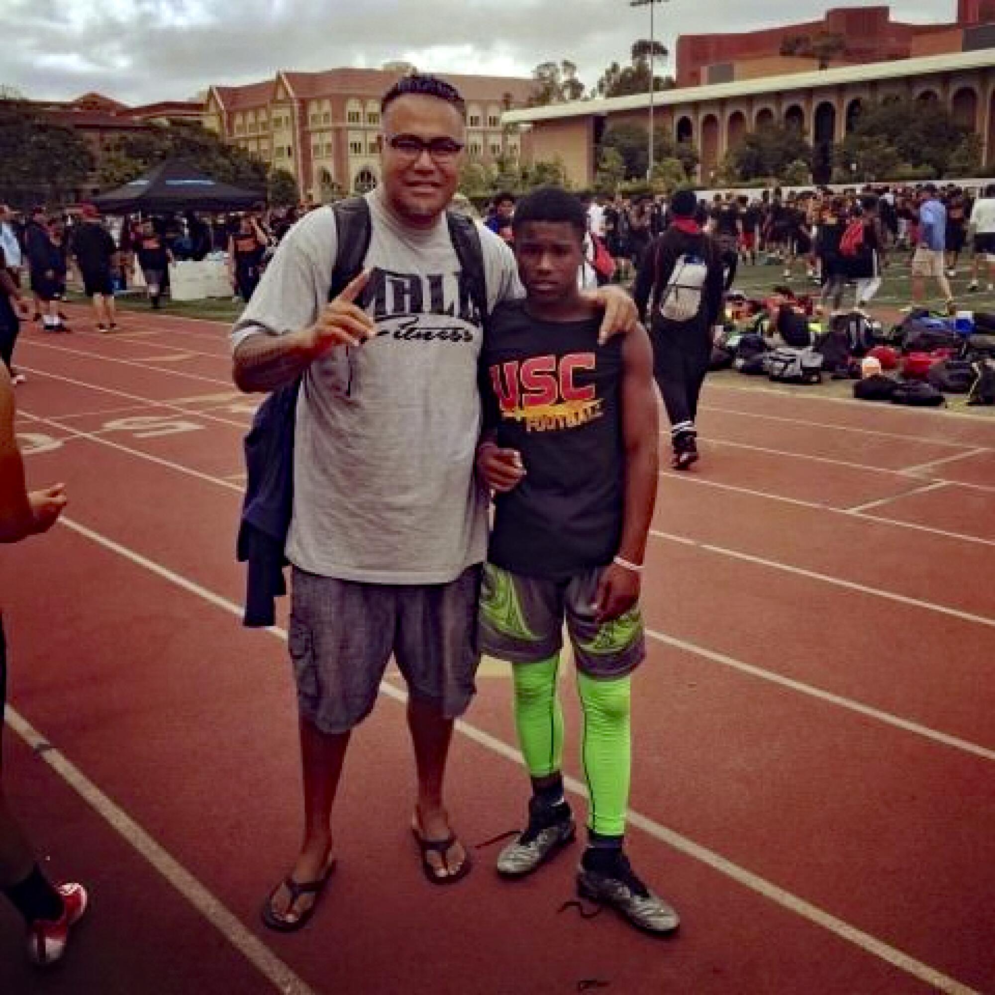 Raleek Brown, right, joins Mori Sue’sue at a USC football camp. 