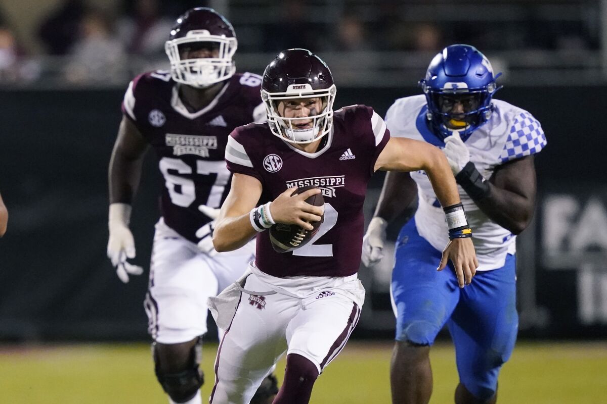 Mississippi State quarterback Will Rogers (2) runs upfield for a first down against Kentucky defenders during the second half of an NCAA college football game in Starkville, Miss., Saturday, Oct. 29, 2021. Mississippi State won 31-17. (AP Photo/Rogelio V. Solis)