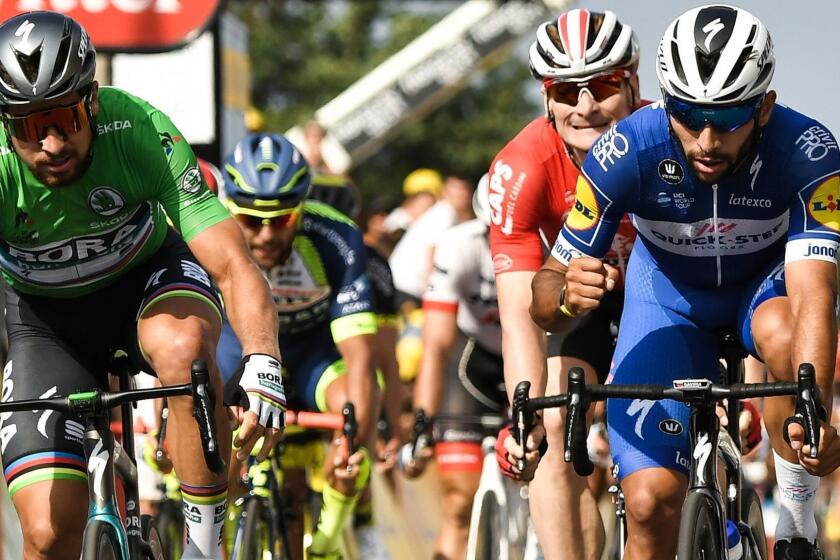 Colombia's Fernando Gaviria (R) reacts after crossing the finish line ahead of Slovakia's Peter Sagan (L) and Germany's Andre Greipel (Rear) to win the fourth stage of the 105th edition of the Tour de France cycling race between La Baule and Sarzeau, western France, on July 10, 2018. / AFP PHOTO / Marco BERTORELLOMARCO BERTORELLO/AFP/Getty Images ** OUTS - ELSENT, FPG, CM - OUTS * NM, PH, VA if sourced by CT, LA or MoD **
