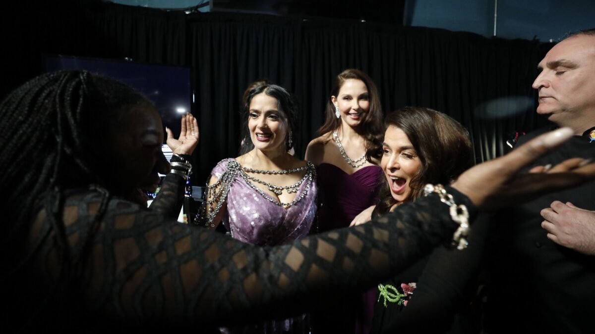 Activist Tarana Burke greets alleged Harvey Weinstein victims Salma Hayek, Ashley Judd, and Annabella Sciorra backstage at the 90th Academy Awards. The three actresses presented onstage at the March 4th awards show.