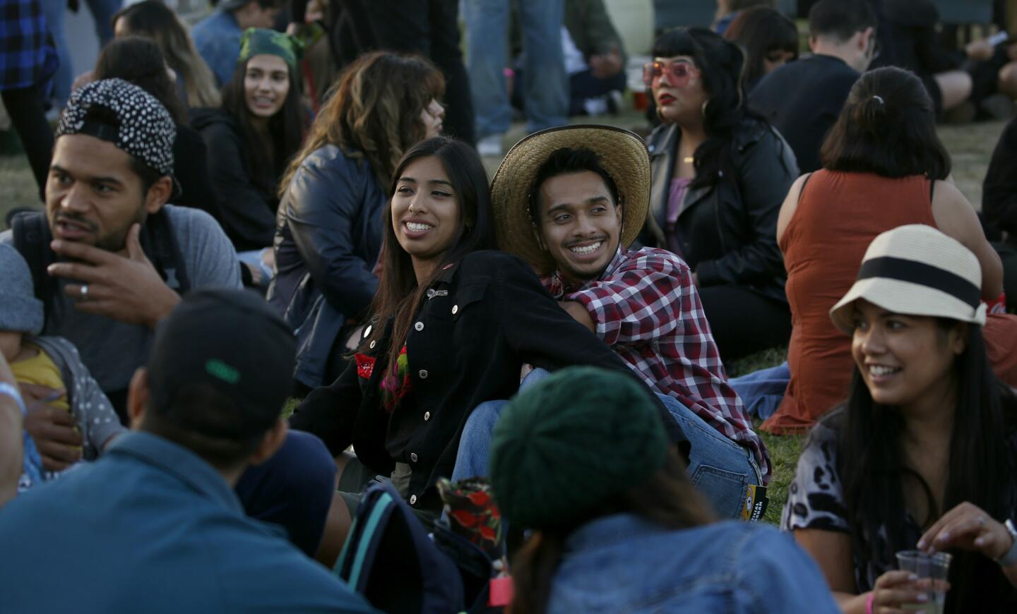 Evellyn Rosas, 21, left, and Neftali Del Rio, 23, attend the Tropicalia Music & Taco Festival in Long Beach.