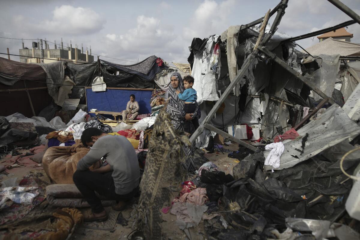 Displaced Palestinians inspect their tents, which have been destroyed by Israel’s bombardment.