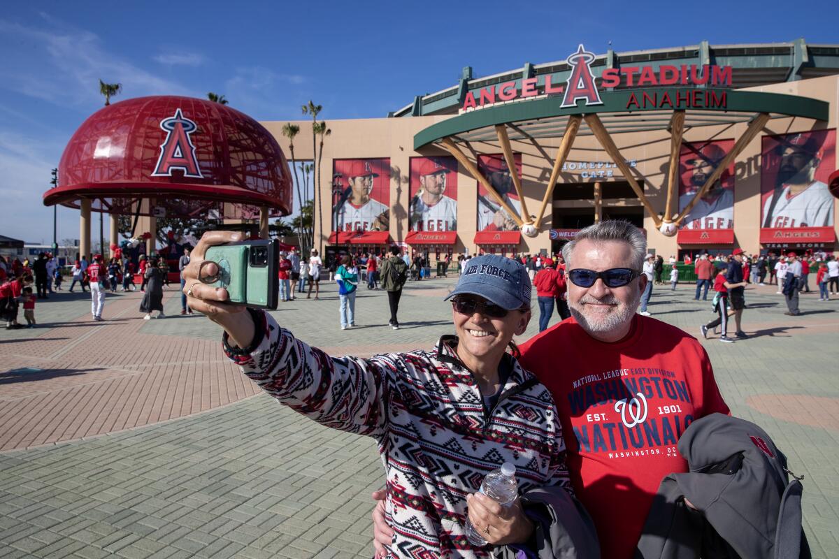 Tammy and Richard Plotter, take a selfie as fans gather outside Angel Stadium before Friday's game.