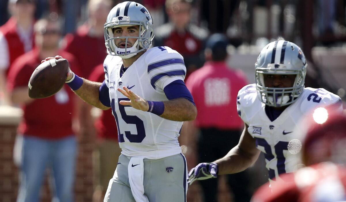 Kansas State quarterback Jake Waters (15) looks for a receiver as he scrambles against Oklahoma in the second quarter Saturday.