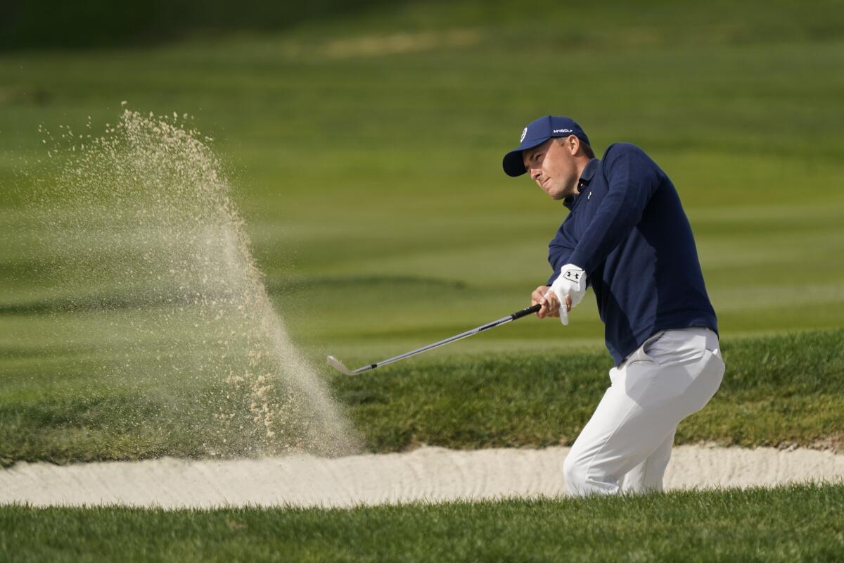 Jordan Spieth follows his shot out of a bunker up to the fourth green during the third round of the AT&T Pebble Beach Pro-Am.