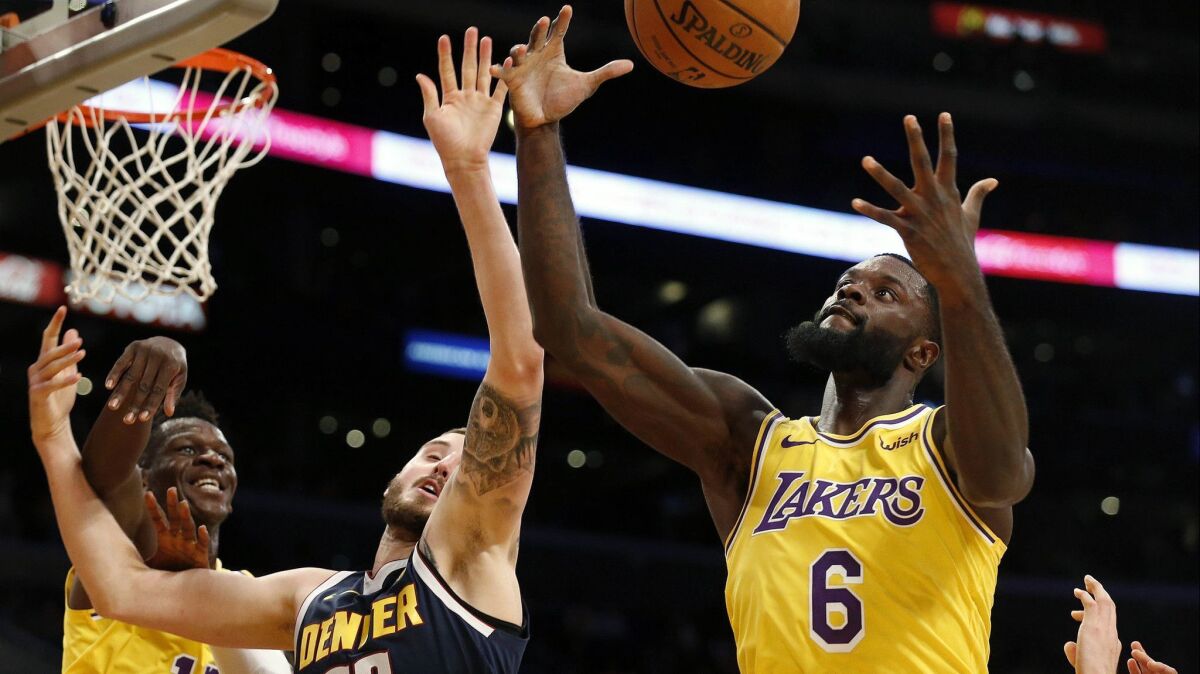Lakers guard Lance Stephenson (6) fights for a rebound against Nuggets forward Tyler Lydon during a preseason game.