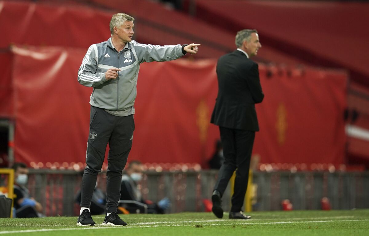 Manchester United's manager Ole Gunnar Solskjaer gestures during the Europa League round of 16 second leg soccer match between Manchester United and LASK at Old Trafford in Manchester, England, Wednesday, Aug. 5, 2020. (AP Photo/Dave Thompson)
