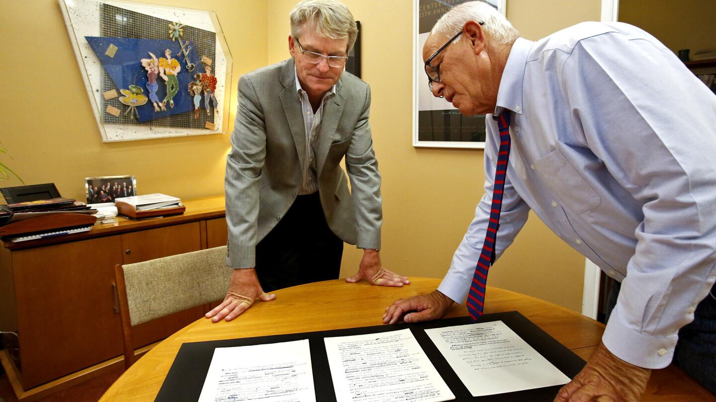 Ed Rada, left, managing director of the Center Theatre Group, and Steve Soboroff, L.A. Police Commission president, look over a manuscript written by Joanne Carson and heavily edited by Truman Capote. The famed writer, a close friend of Carson's, died in her home in 1984.