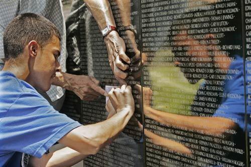 Albert Quintero of Hollywood traces the name of his uncle Fernando Mendoza Quintero on the Dignity Memorial Vietnam Wall, a traveling three-quarter-scale replica of the Vietnam Veterans Memorial in Washington. The wall was at Pierce Brothers Valhalla Memorial Park in North Hollywood over the weekend.