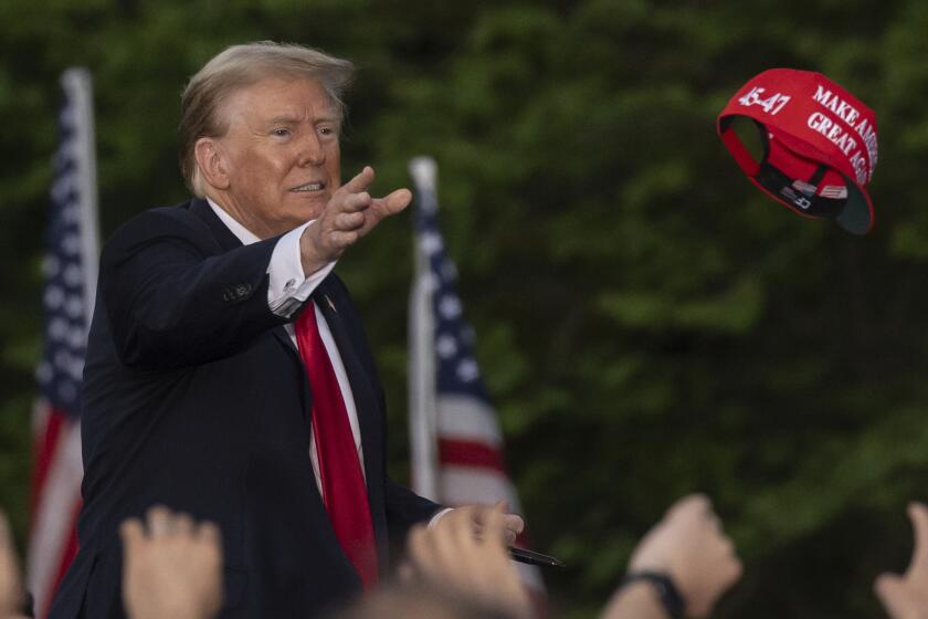 Republican presidential candidate former President Donald Trump throws a "MAGA" hat during a campaign rally in the south Bronx, Thursday, May. 23, 2024, in New York. (AP Photo/Yuki Iwamura)