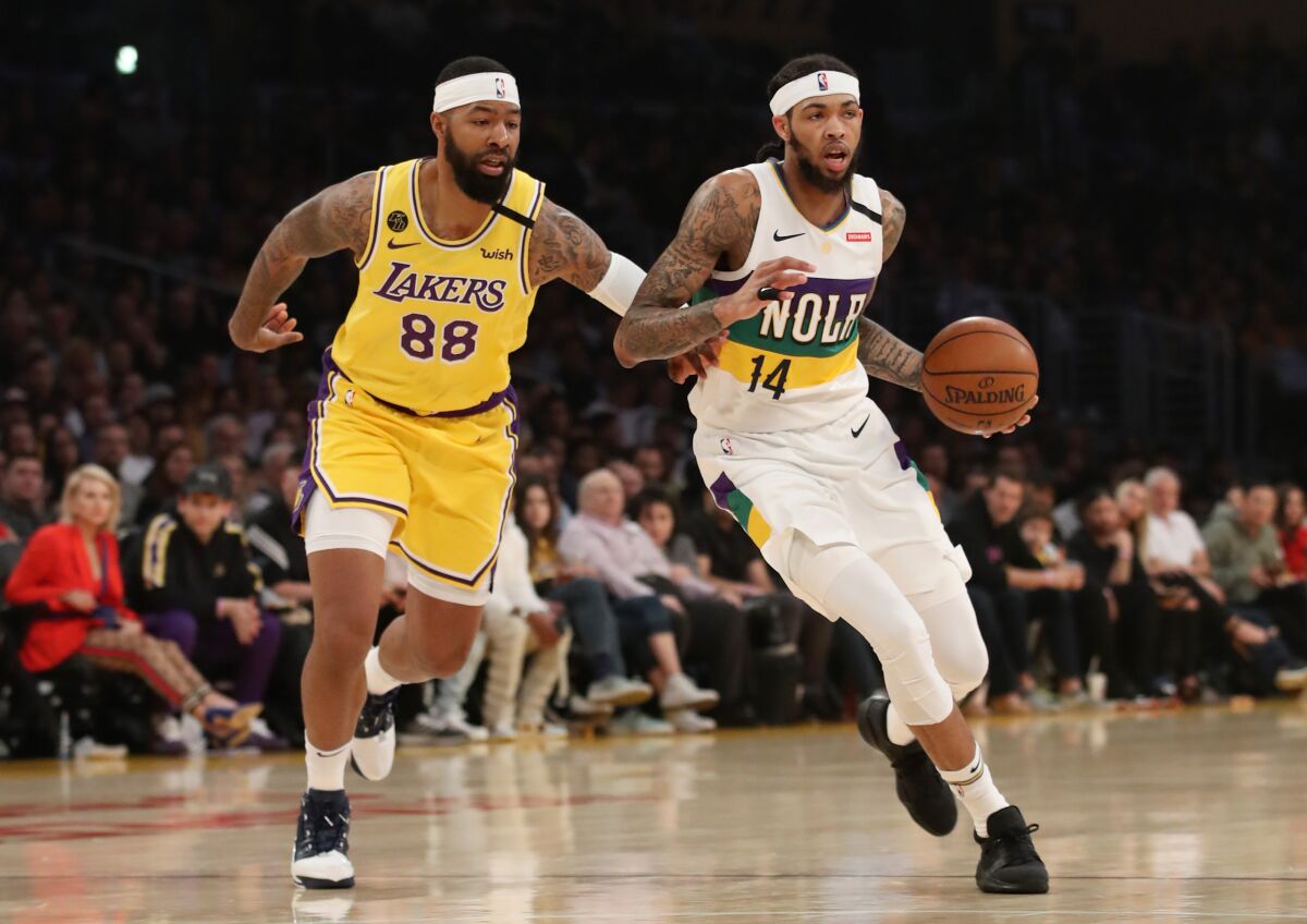Lakers forward Markieff Morris, left, guards New Orleans Pelicans forward Brandon Ingram during the Lakers' win Feb. 25, 2020.