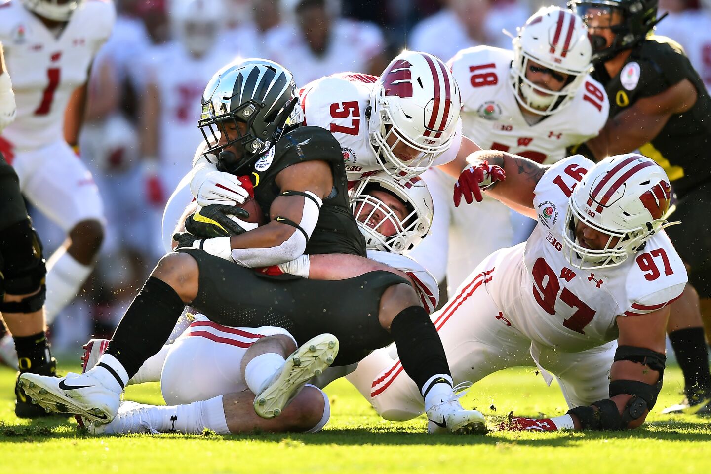 Oregon running back CJ Verdell is stopped by the Wisconsin defense in the first quarter at the Rose Bowl.
