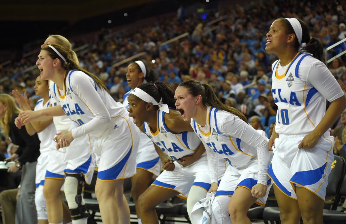 Members of UCLA's team celebrate from the bench during the second half of an NCAA college basketball game against USC in January.