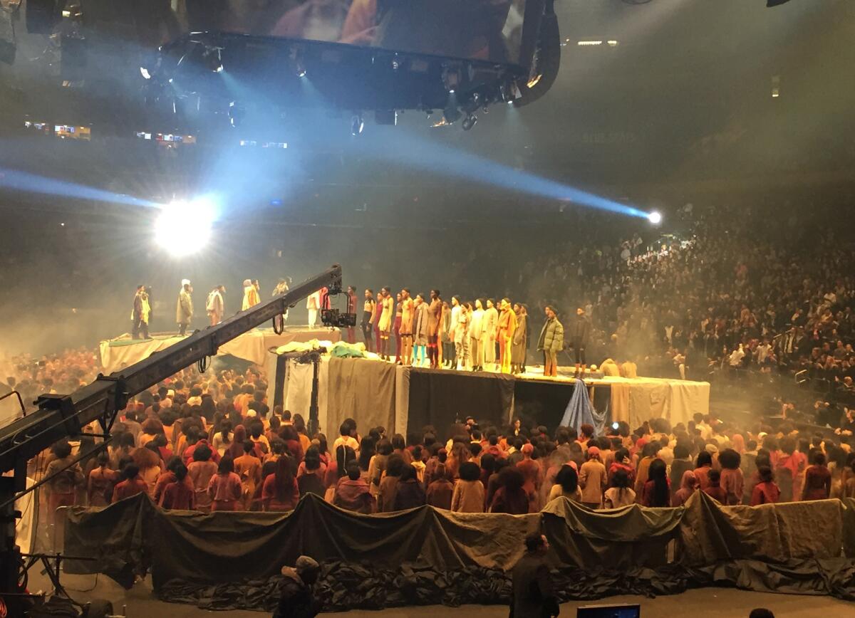 Models stand onstage as Kanye West presents his Yeezy collection at Madison Square Garden during Fashion Week on Thursday in New York.
